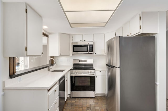 kitchen with sink, white cabinets, and stainless steel appliances