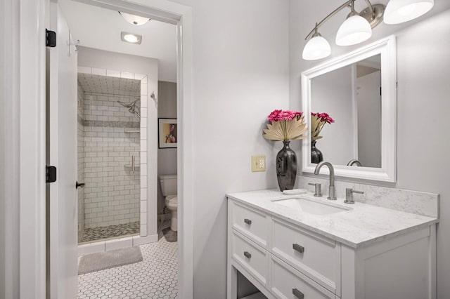 bathroom with toilet, tile patterned floors, a shower with shower door, and vanity