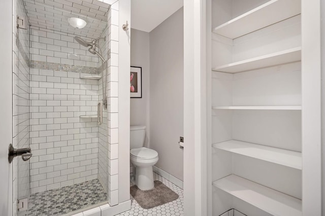 bathroom featuring toilet, tile patterned flooring, and an enclosed shower