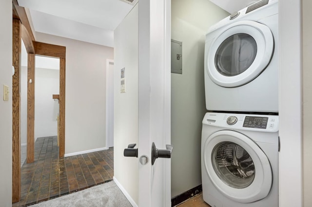 washroom featuring stacked washer and clothes dryer