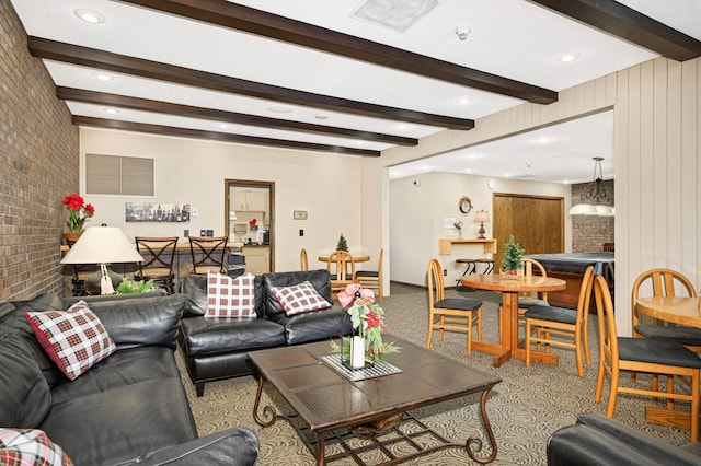 carpeted living room featuring brick wall and beamed ceiling