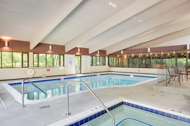 view of swimming pool with an indoor hot tub