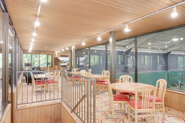 sunroom with track lighting and wooden ceiling