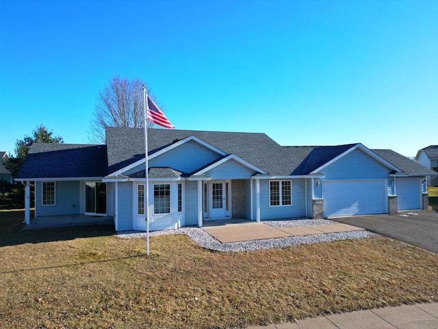 ranch-style house featuring a front lawn, a porch, and a garage