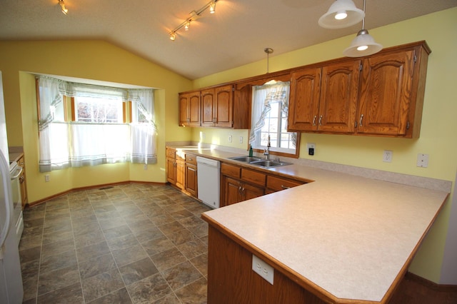 kitchen with dishwasher, sink, hanging light fixtures, vaulted ceiling, and kitchen peninsula