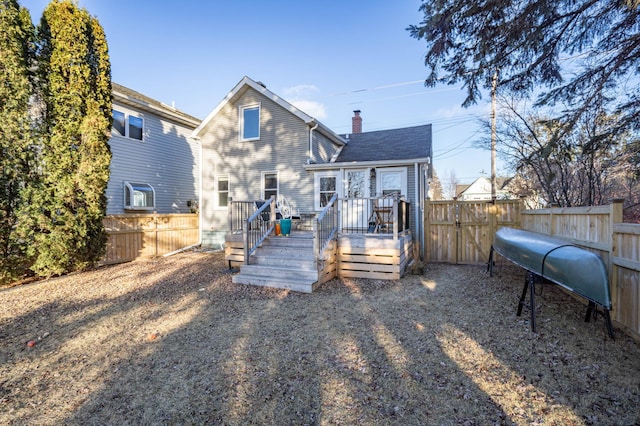 back of property with a wooden deck