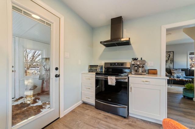 kitchen featuring light hardwood / wood-style floors, white cabinetry, electric stove, and range hood