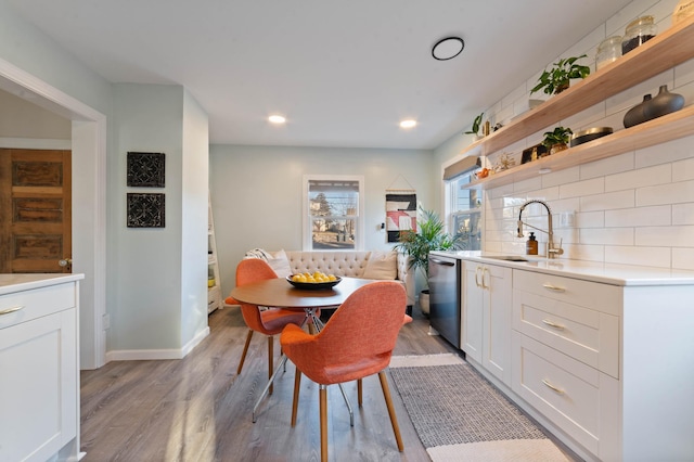 dining space featuring breakfast area, light hardwood / wood-style floors, and sink