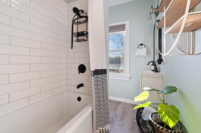 bathroom featuring shower / bath combination with curtain, wood-type flooring, and sink