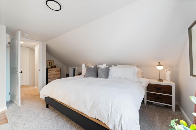 carpeted bedroom featuring vaulted ceiling