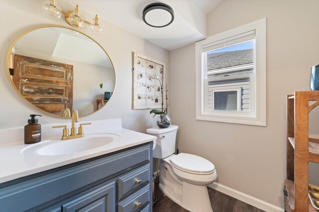 bathroom with hardwood / wood-style flooring, vanity, and toilet