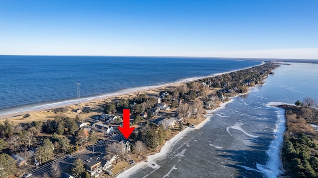 drone / aerial view featuring a water view and a view of the beach