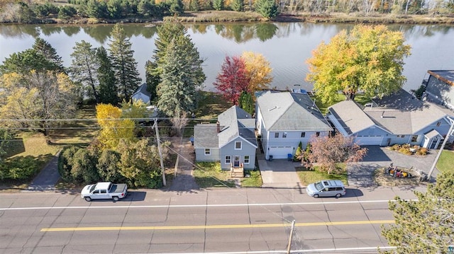 birds eye view of property with a water view