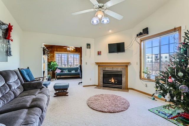 living room featuring ceiling fan, a premium fireplace, and carpet floors