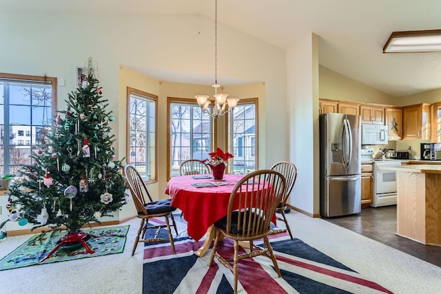 dining space with lofted ceiling and a notable chandelier