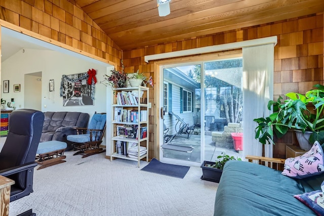 interior space with lofted ceiling, carpet floors, wood ceiling, and wood walls