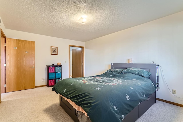 bedroom featuring carpet and a textured ceiling