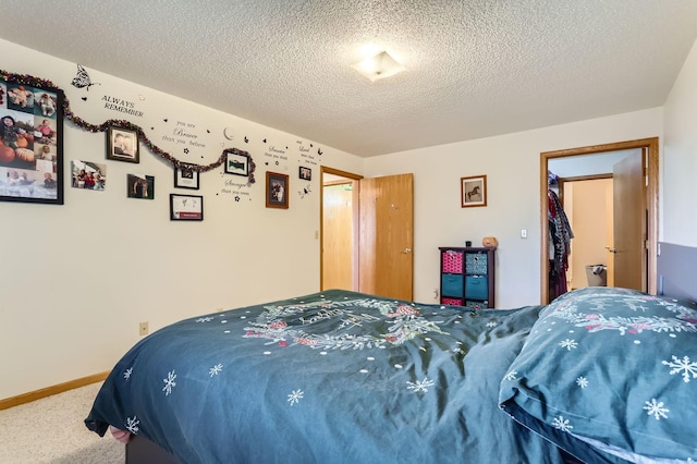 bedroom with carpet floors, a textured ceiling, and a closet