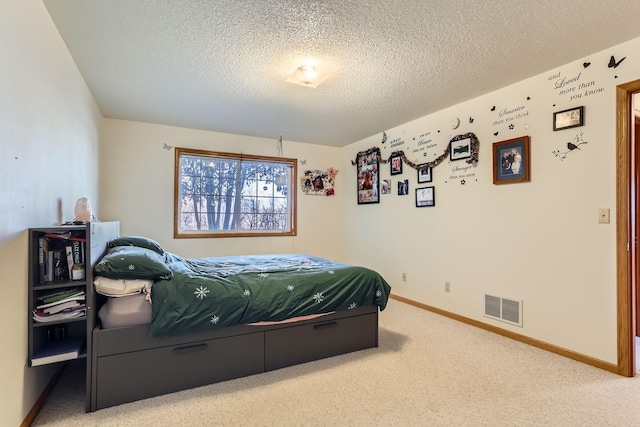 bedroom with a textured ceiling and carpet