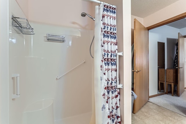 bathroom featuring a textured ceiling and a shower with shower curtain