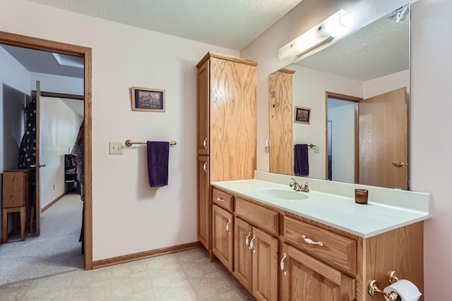 bathroom with vanity and a textured ceiling