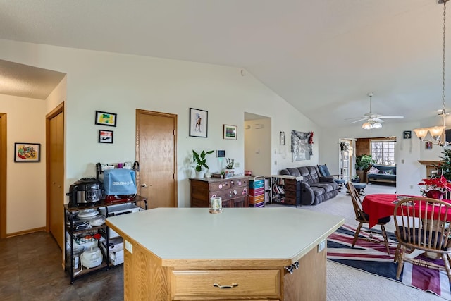 kitchen featuring a center island, light countertops, a ceiling fan, open floor plan, and vaulted ceiling