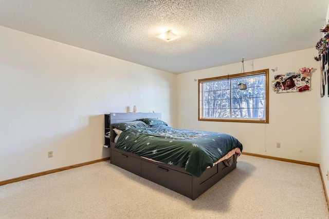 bedroom featuring a textured ceiling, baseboards, and carpet flooring