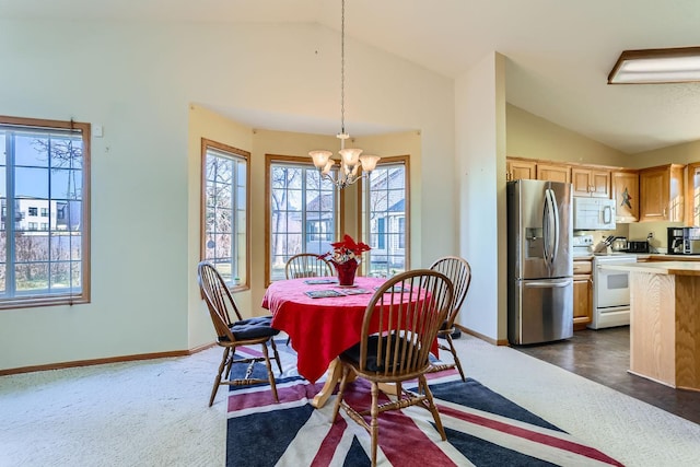 dining area featuring lofted ceiling, a healthy amount of sunlight, and baseboards