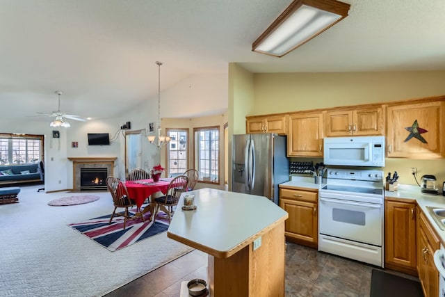 kitchen with white appliances, lofted ceiling, open floor plan, decorative light fixtures, and light countertops