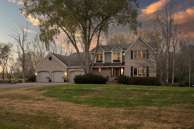 view of front of home featuring a yard and a garage