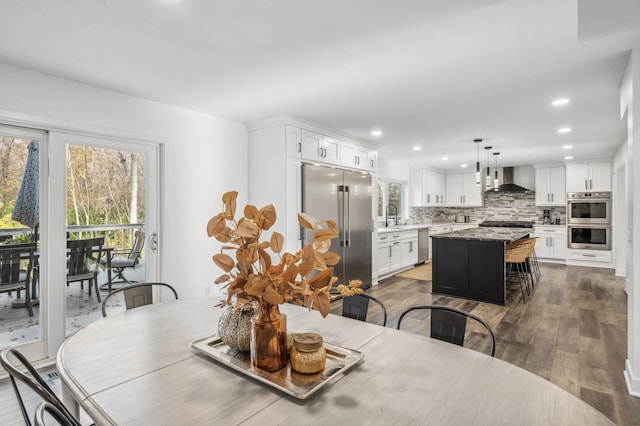 dining space with dark hardwood / wood-style flooring and sink