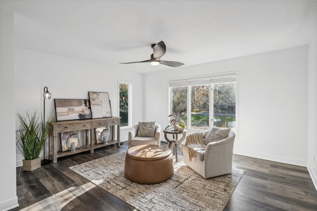 sitting room with dark hardwood / wood-style floors and ceiling fan