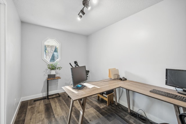 office with rail lighting, dark hardwood / wood-style flooring, and a textured ceiling