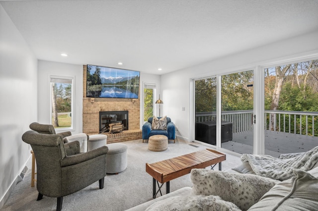 living room featuring carpet and a brick fireplace