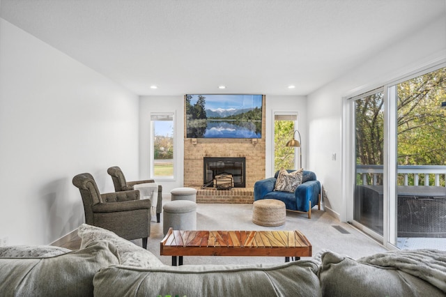 carpeted living room with a brick fireplace