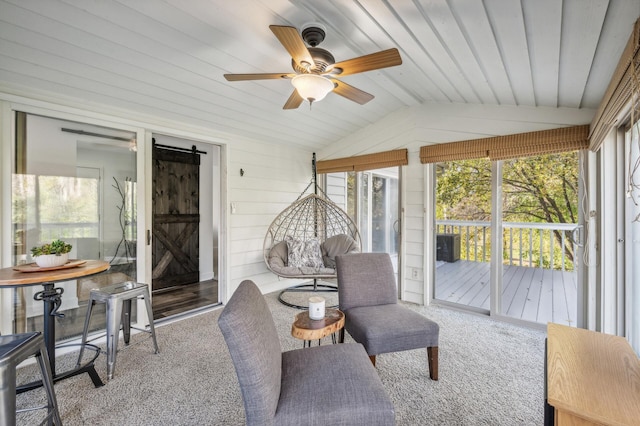 sunroom with a barn door, ceiling fan, and lofted ceiling