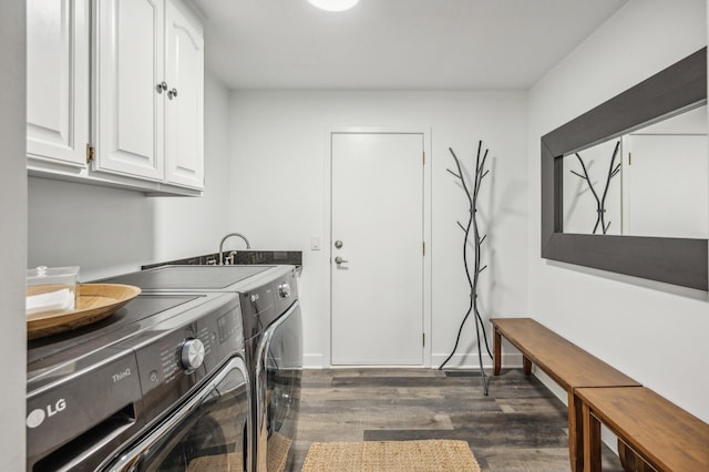 laundry room with cabinets, washing machine and dryer, and dark hardwood / wood-style floors