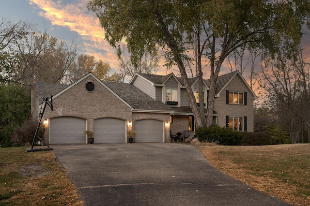 view of front of home featuring a garage and a yard