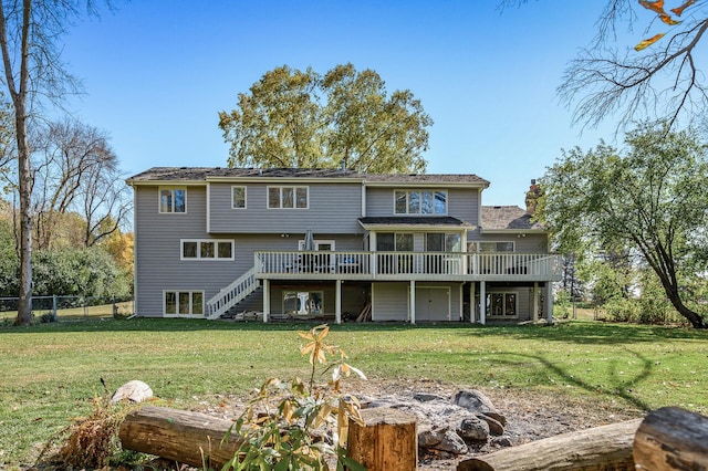 back of house featuring a yard and a wooden deck