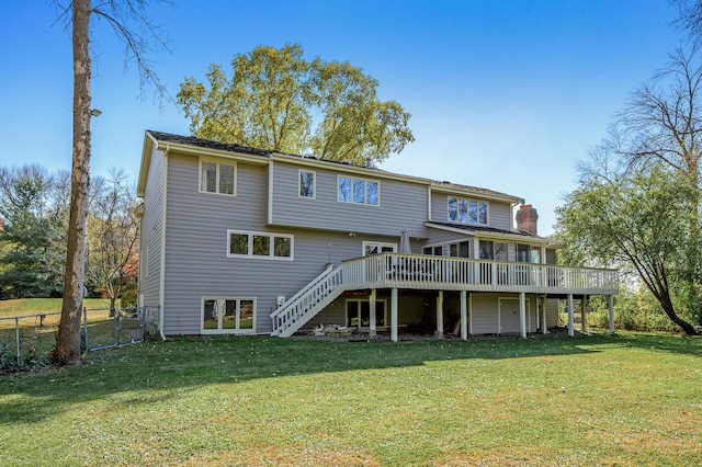 rear view of property with a deck and a yard