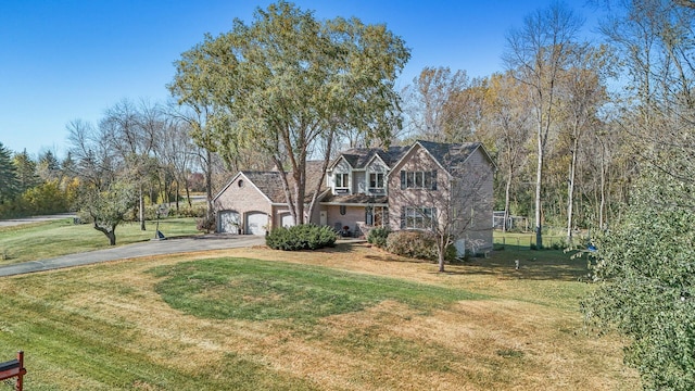 view of front of house with a front yard and a garage