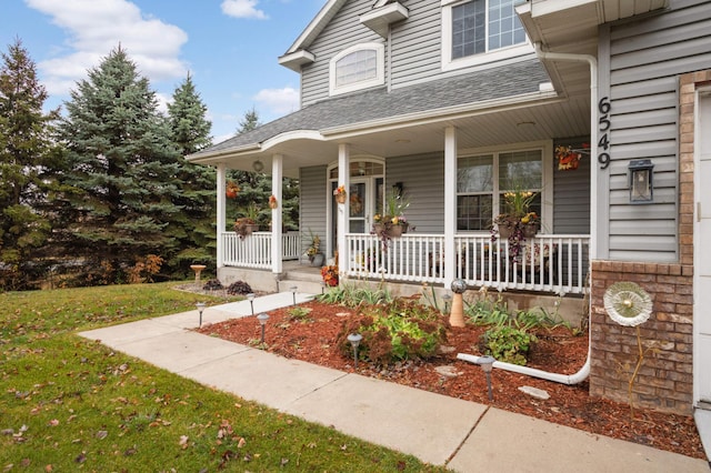 view of front facade with covered porch and a front lawn