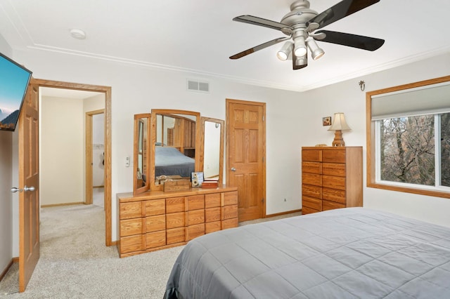 bedroom with ceiling fan, carpet floors, and ornamental molding