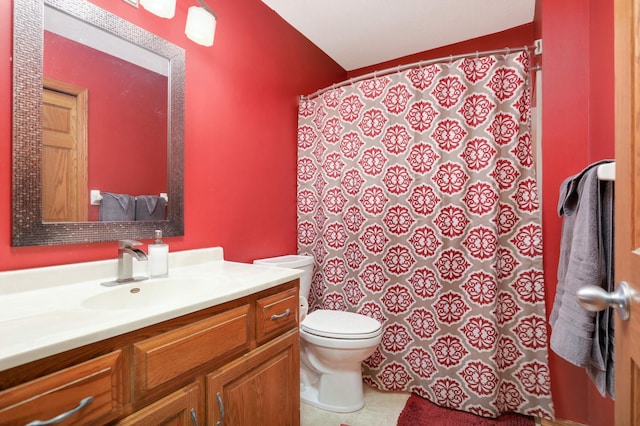 bathroom with tile patterned flooring, vanity, and toilet