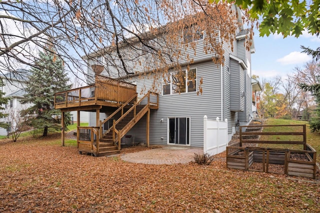 back of property with a patio and a wooden deck