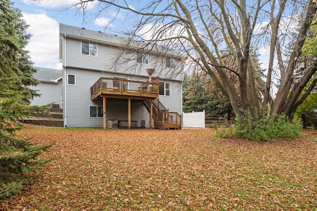 rear view of house featuring a deck