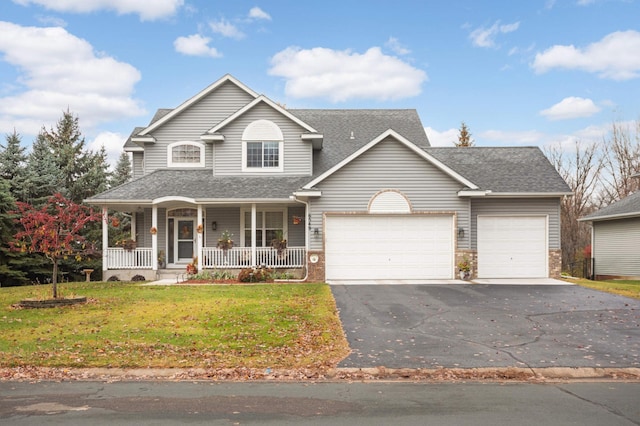 view of front of house featuring covered porch, a front yard, and a garage