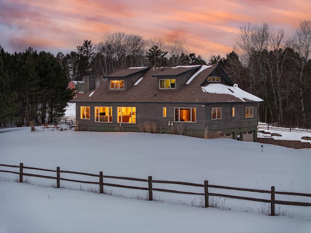 view of snow covered rear of property