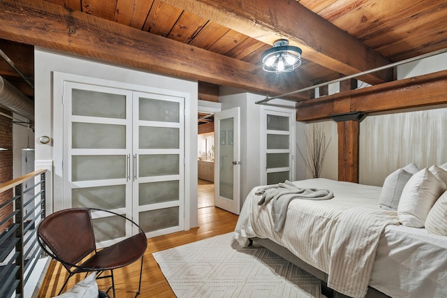 bedroom with beam ceiling, light hardwood / wood-style flooring, french doors, and wooden ceiling