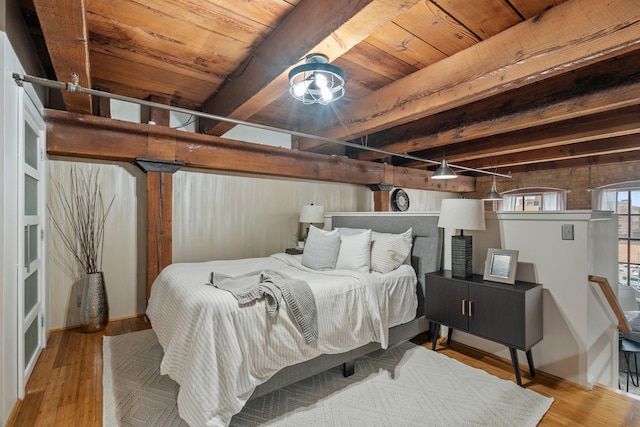 bedroom with light wood-type flooring and wood ceiling